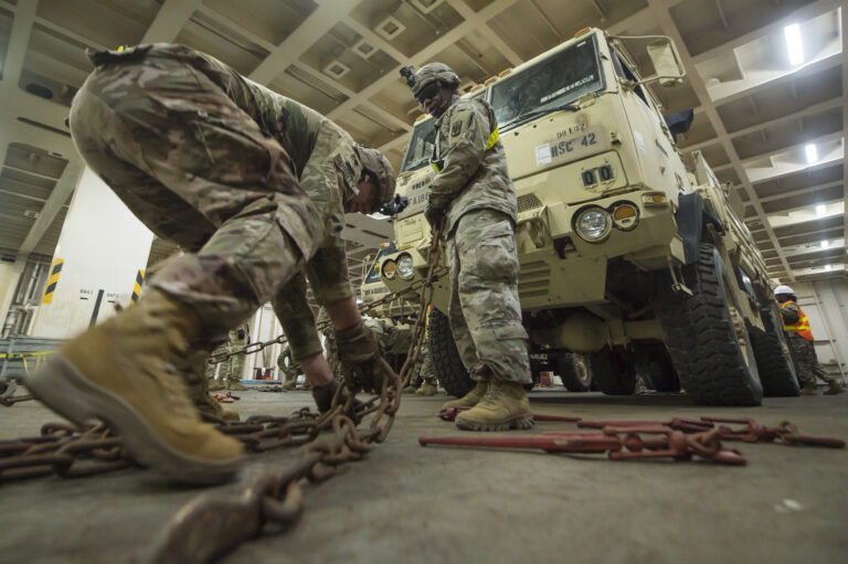 U.S. Army Spc. Robert Smedley, left, and U.S. Army Staff Sgt. Conrad Stewart, both assigned to the 18th Field Artillery Brigade, 188th Brigade Support Battalion from Fort Bragg, N.C., secure a military vehicle onto the Logistics Naval Vessel Cape Decision during Exercise Dragon Lifeline Aug. 7, 2019, at the Federal Law enforcement Training Center in Charleston, S.C. The exercise provided military personnel with experience needed to support rapid deployment operations across air, land, rail and sea. JB Charleston helps to provide rapid global deployment of personnel and equipment to deployed locations across the globe. The annual exercise is just one of the critical readiness exercises the DOD conducts to maintain a lethal and ready force. (U.S. Air Force photo by Tech. Sgt. Christopher Hubenthal)