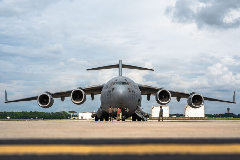 U.S. Air Force 437th Airlift Wing personnel conduct engine start of a C-17 Globemaster III for a flyover of the Charleston Battery stadium, at Joint Base Charleston, South Carolina, May 30, 2026. All aerial missions require precise work from squadron beyond the aircrew, such as maintenance and operations support, in communication to launch and receive aircraft safely. (U.S. Air Force photo by Senior Airman Rachel Pakenas)