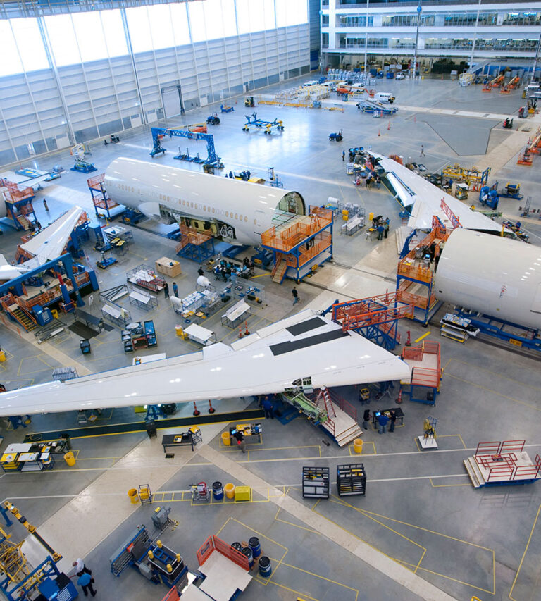 An airplane being constructed inside of a Boeing warehouse.