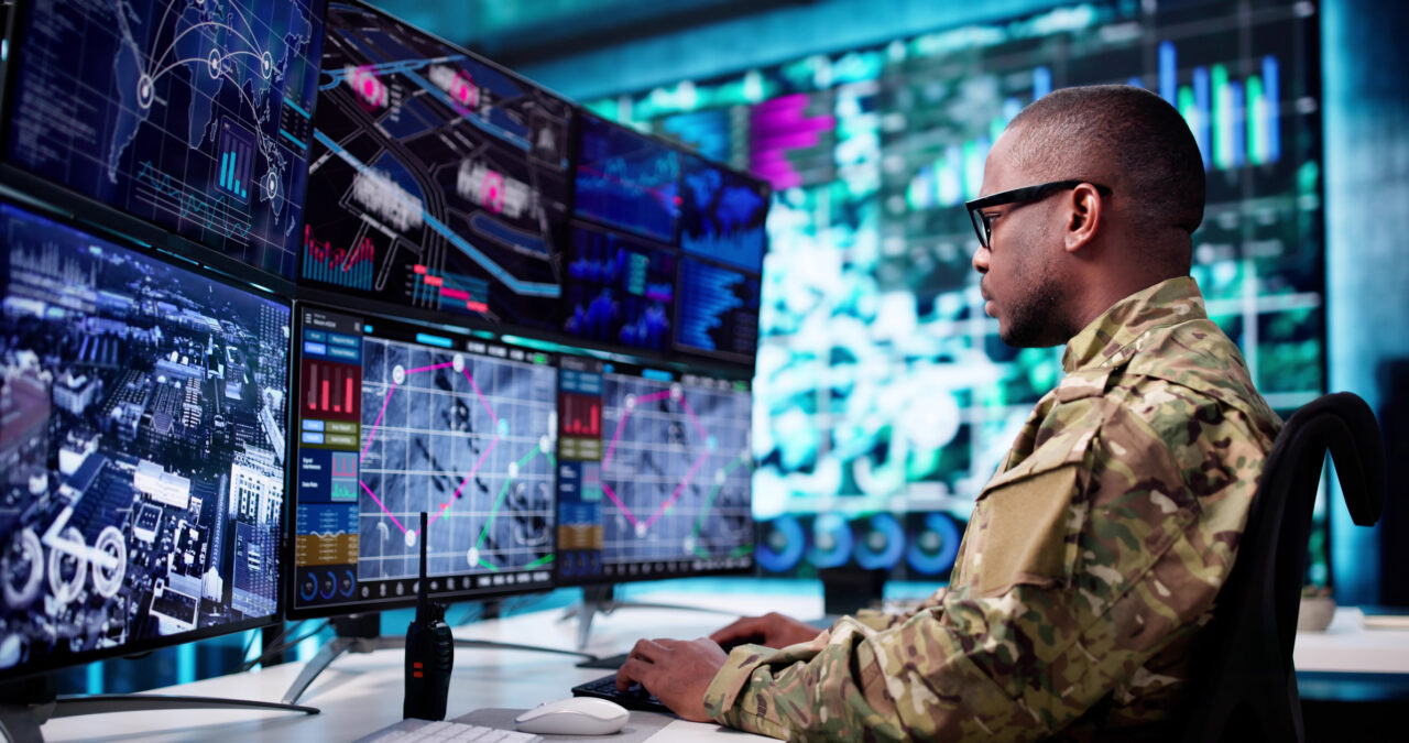 Military & Defense Image of Man working on screens in a military environment