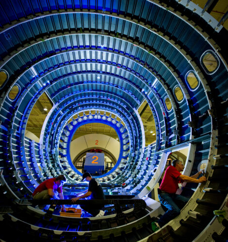 Three people work on the interior of an aircraft at the Boeing facility in Charleston, SC.