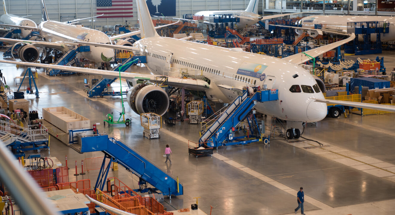 Four passenger airplanes sit in a hangar in the Charleston region.