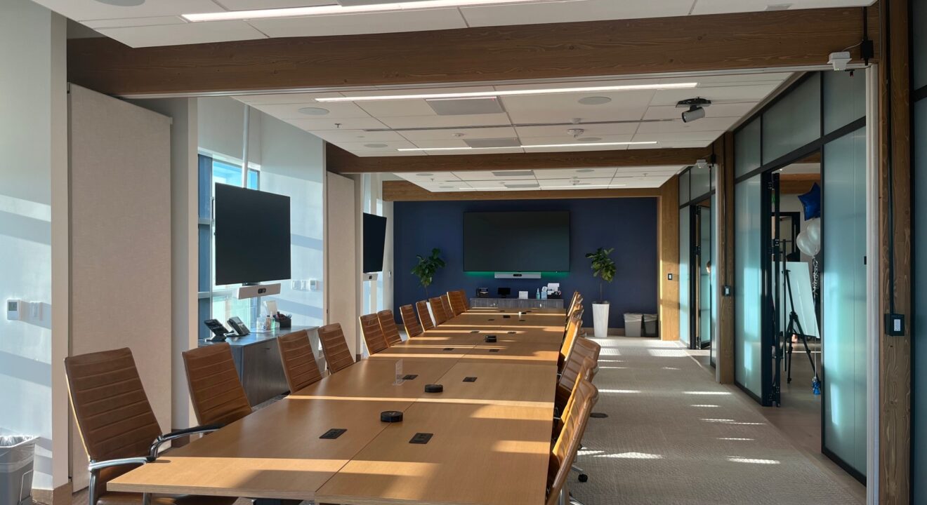 The interior of a modern corporate boardroom during the day.