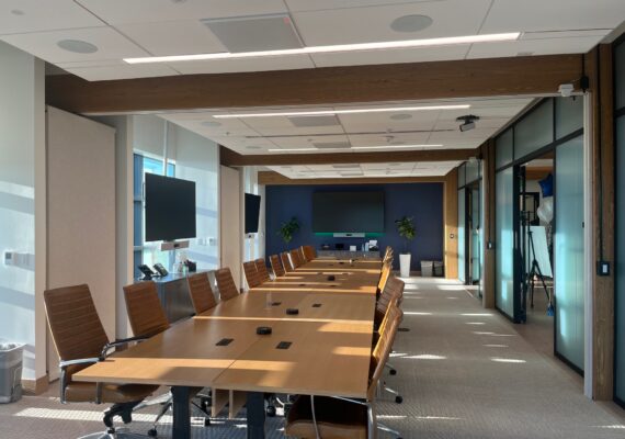 The interior of a modern corporate boardroom during the day.