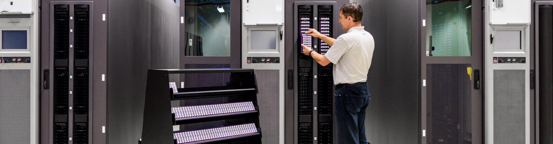 A man works in a data storage facility.