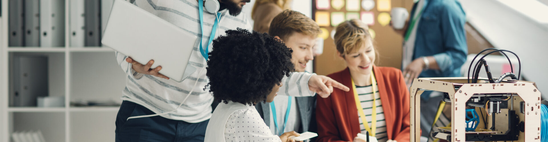 A tech worker speaks to a coworker in a shared office space.