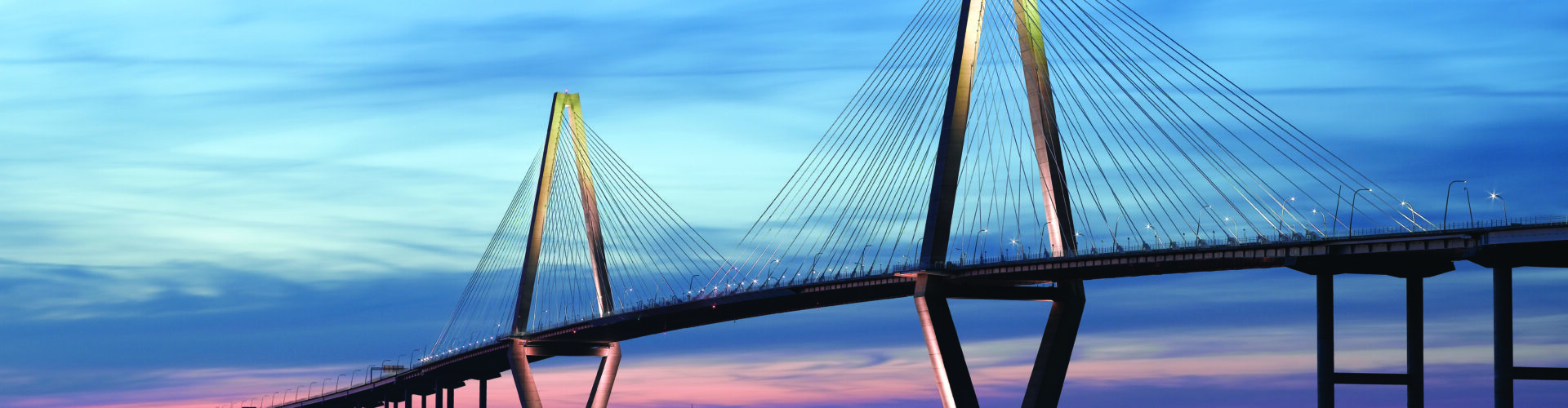 A wide shot of the Ravenel Jr. Bridge in South Carolina at dusk.