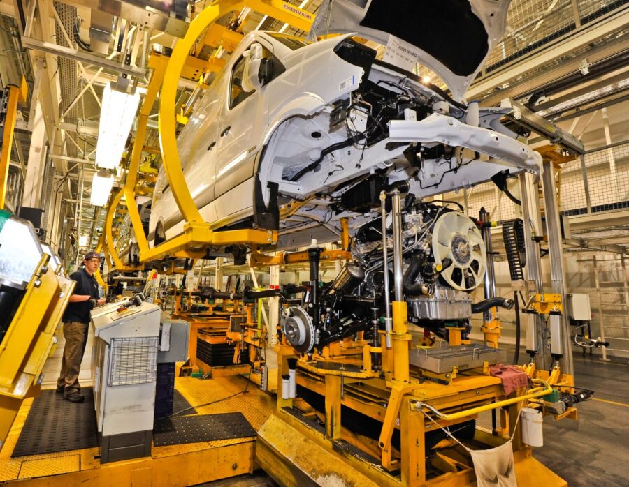 The body of a car is elevated while being worked on at a manufacturing facility in the Charleston region.