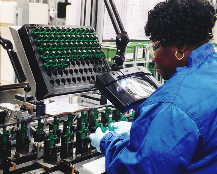 A worker sorts equipment at a Bosch manufacturing facility.