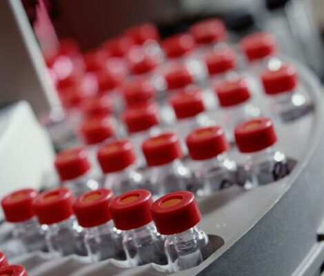 A close-up of vials with red caps in a lab.